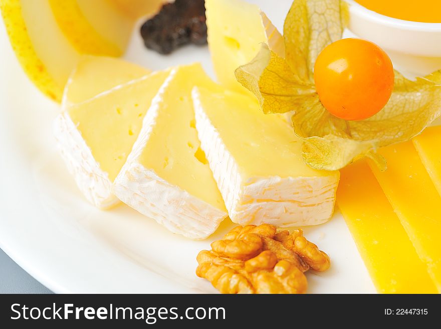 Bites of different cheeses with honey  and nuts. Bites of different cheeses with honey  and nuts