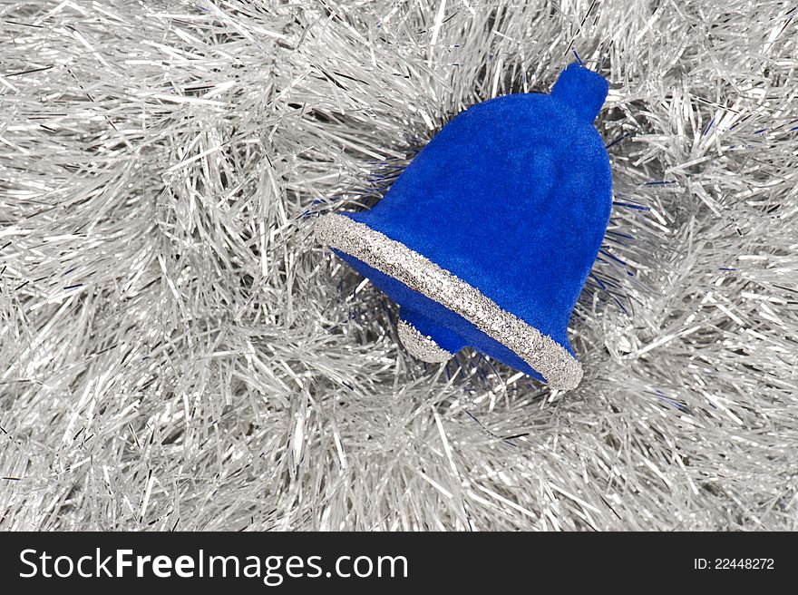 A blue Christmas decoration on silver tinsel. A blue Christmas decoration on silver tinsel