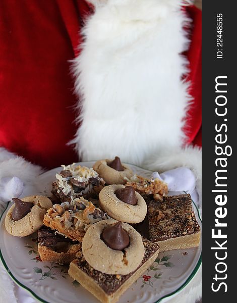 Santa Claus holding a plate of Christmas cookies. Santa Claus holding a plate of Christmas cookies.