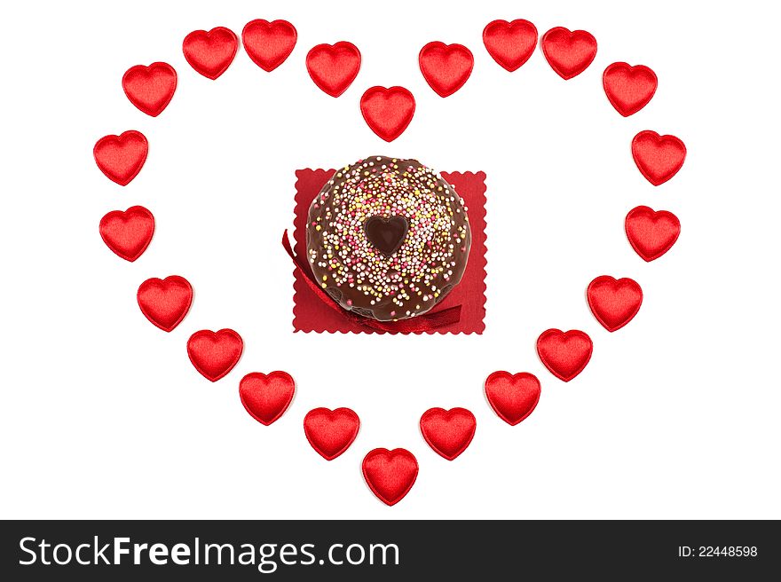 A valentine muffin surrounded by red hearts