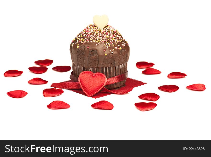 A valentine muffin surrounded by red hearts, isolated on white