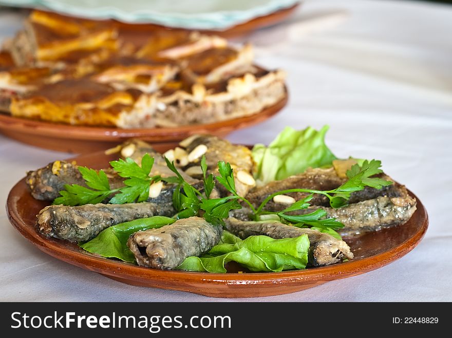 Fish marinade and eel pie dish to background, from Galicia, Spain