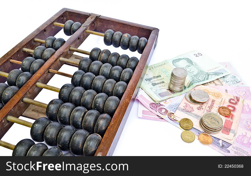 Old abacus and many kind of Thailand's money on white background. Old abacus and many kind of Thailand's money on white background