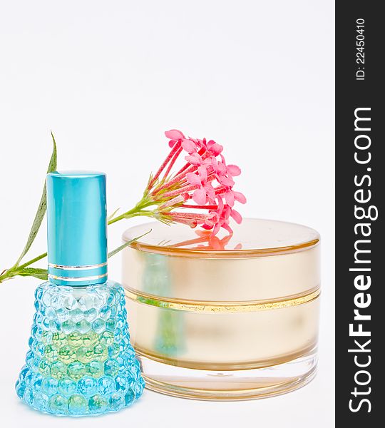 Blue perfume bottle and powder with flower on white background. Blue perfume bottle and powder with flower on white background