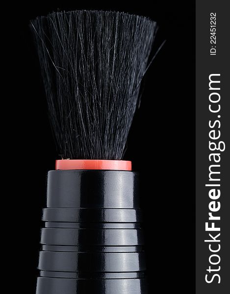 A lens brush on a black background