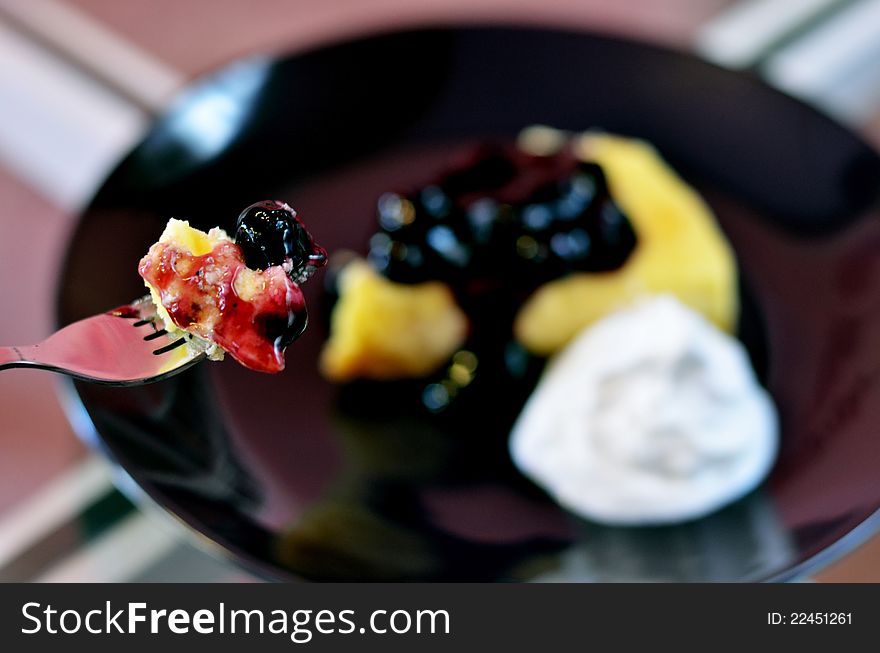 Close-up of blueberry cheese cake on fork. Close-up of blueberry cheese cake on fork