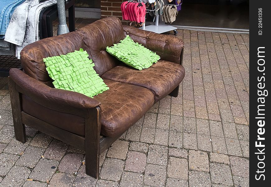 Abandoned old leather sofa laid in a city street. Abandoned old leather sofa laid in a city street