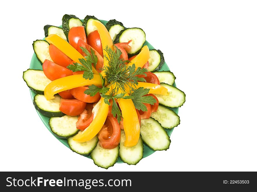 Salad of fresh vegetables on the green plate, isolated on a white background. Salad of fresh vegetables on the green plate, isolated on a white background.