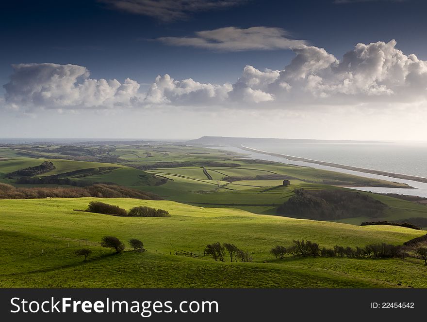 View of Chesil Beach with historic St Catherine's Chapel and Portland in the distance. View of Chesil Beach with historic St Catherine's Chapel and Portland in the distance