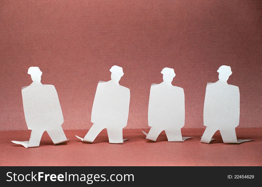 Paper images of people standing on their knees. Paper images of people standing on their knees