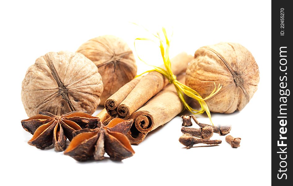 Cinnamon sticks, star anise, walnuts and cloves on a white background. Cinnamon sticks, star anise, walnuts and cloves on a white background