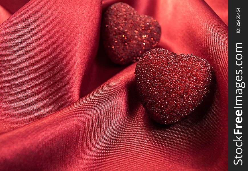 Hearts on a red satin background. Hearts on a red satin background