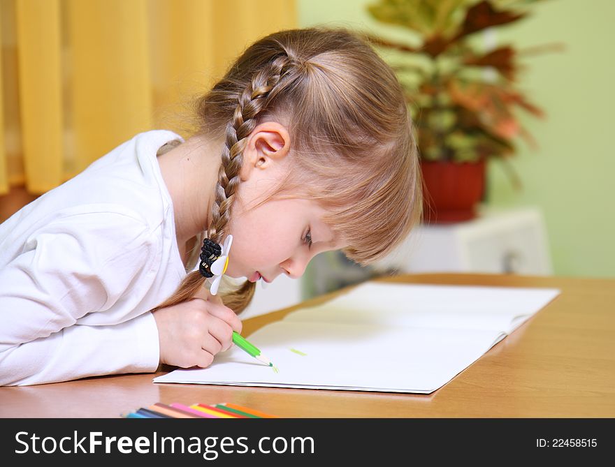 Cute child draw with colorful crayons