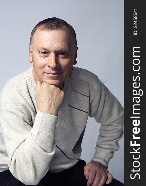 Portrait of an aged man over grey background