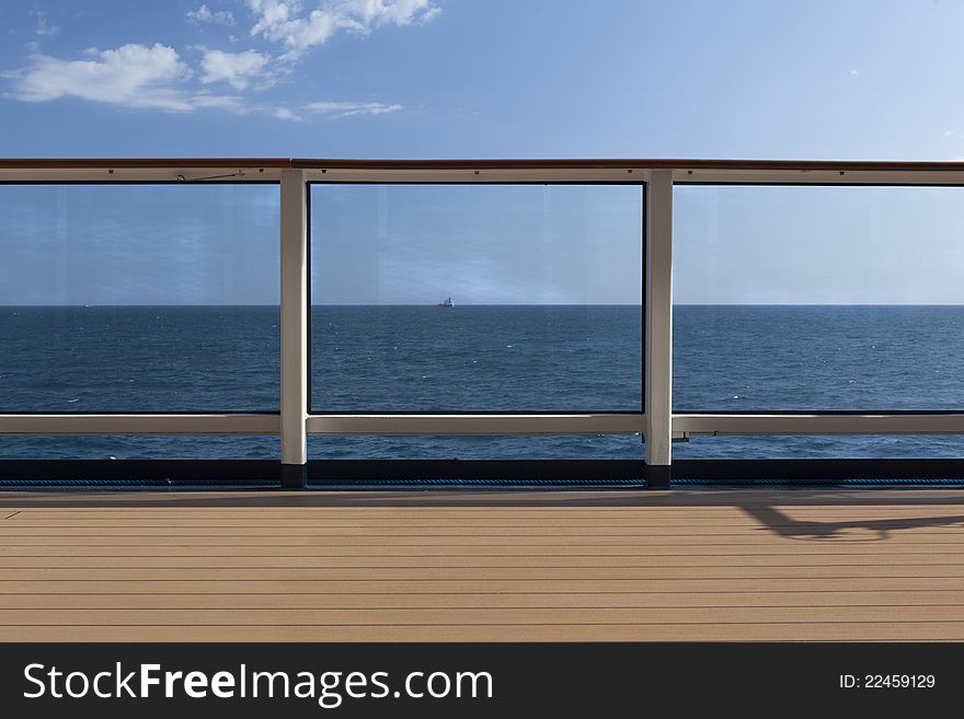 A ocean view from a boat thru the safety rail. A ocean view from a boat thru the safety rail