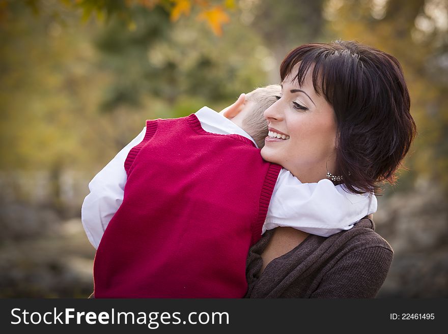 Attractive Mother and Cute Son Portrait Outside at the Park. Attractive Mother and Cute Son Portrait Outside at the Park.