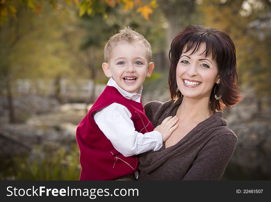 Attractive Mother and Cute Son Portrait Outside at the Park. Attractive Mother and Cute Son Portrait Outside at the Park.