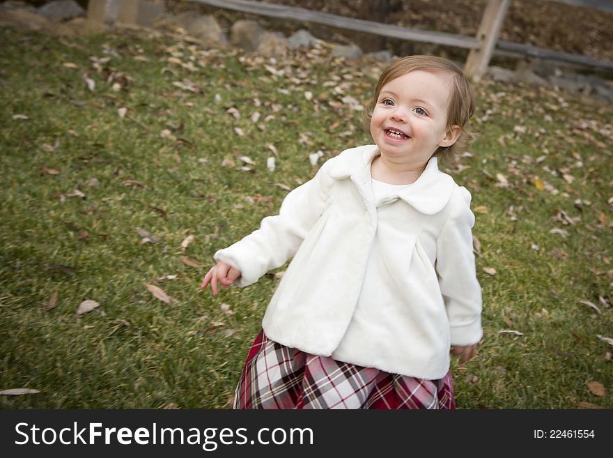 Adorable Baby Girl Playing Outside in the Park. Adorable Baby Girl Playing Outside in the Park.