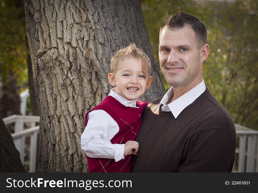 Handsome Father and Son Having Fun in the Park. Handsome Father and Son Having Fun in the Park.