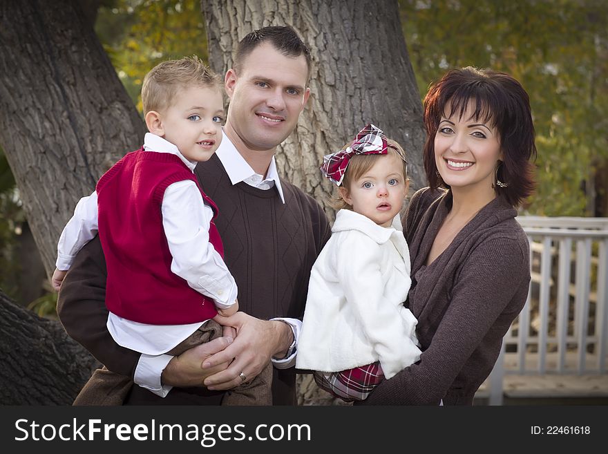 Young Attractive Parents and Children Portrait in Park