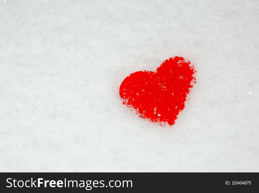 Red heart on the snow - st.valentine's symbol