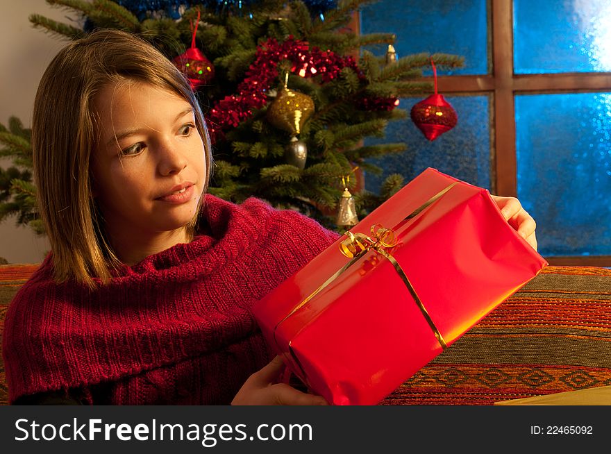 Surprised Girl  Studying Christmas Gift