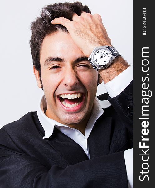 Attractive young businessman laughing before the camera. Attractive young businessman laughing before the camera