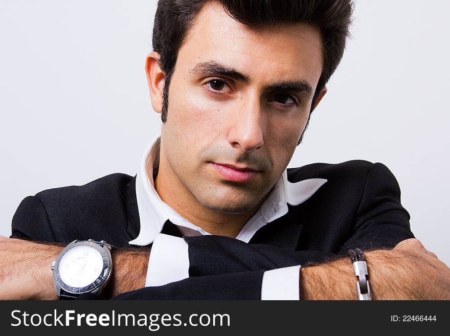 Attractive young businessman posing and looking at the camera. Attractive young businessman posing and looking at the camera