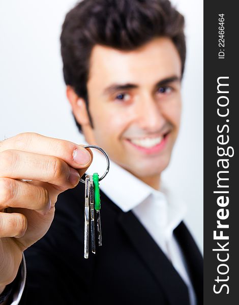 Attractive young seller showing a house key to the camera. Attractive young seller showing a house key to the camera