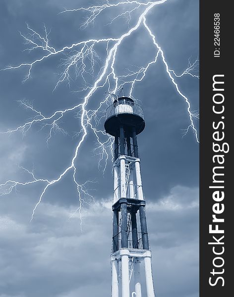 Lightning over the lighthouse in autumn