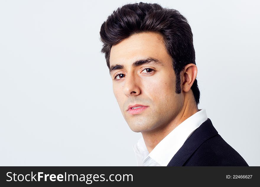 Attractive young businessman posing in front of the camera. Attractive young businessman posing in front of the camera
