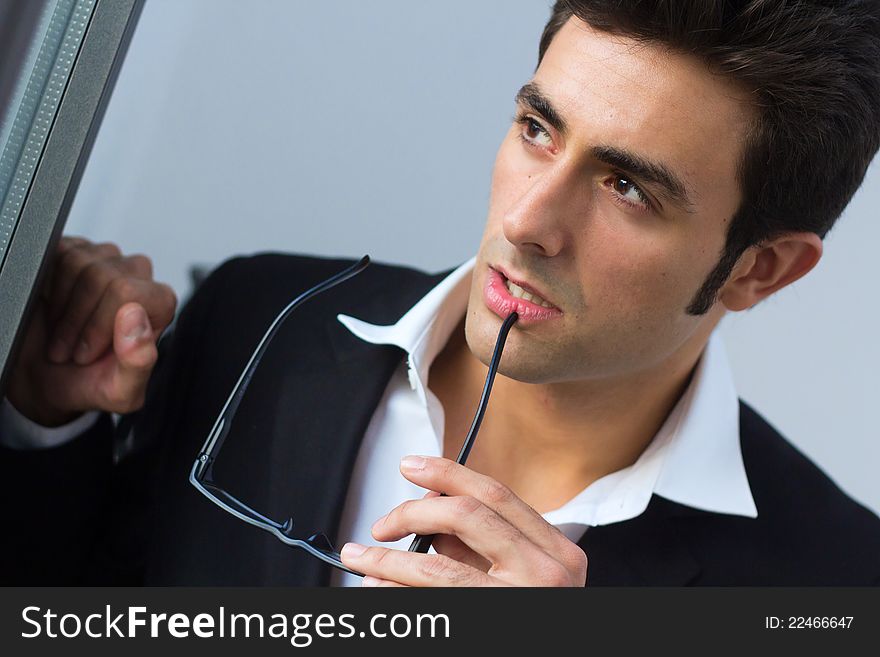 Portrait of attractive young businessman thinking. Portrait of attractive young businessman thinking