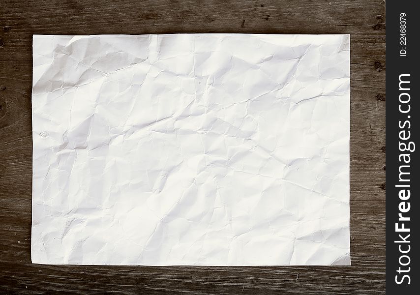 Crumpled Paper On Wooden Background