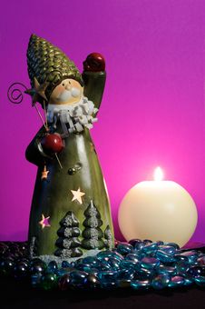 Santa Claus And Candle On Magic Purple Background Royalty Free Stock Photography