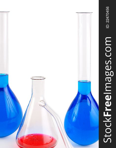 Laboratory flasks with blue and red liquid, white background