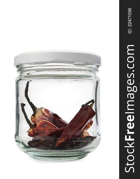 Dried red chilis pepper in a glass jar on a white background. Dried red chilis pepper in a glass jar on a white background