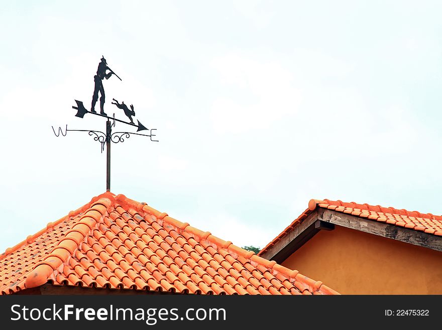 Black Compass wind on red roof. Black Compass wind on red roof