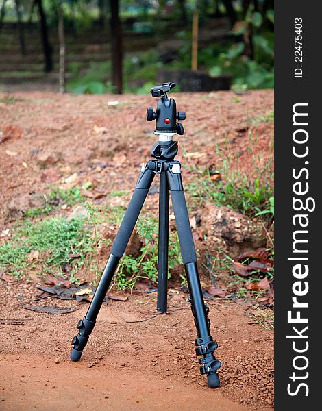 Camera Tripod with natural background of red soil. Camera Tripod with natural background of red soil