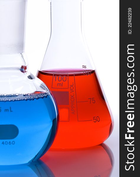 One blue and one red laboratory flask used in scientific research. One blue and one red laboratory flask used in scientific research