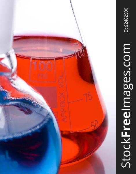 One blue and one red laboratory flask used in scientific research. One blue and one red laboratory flask used in scientific research