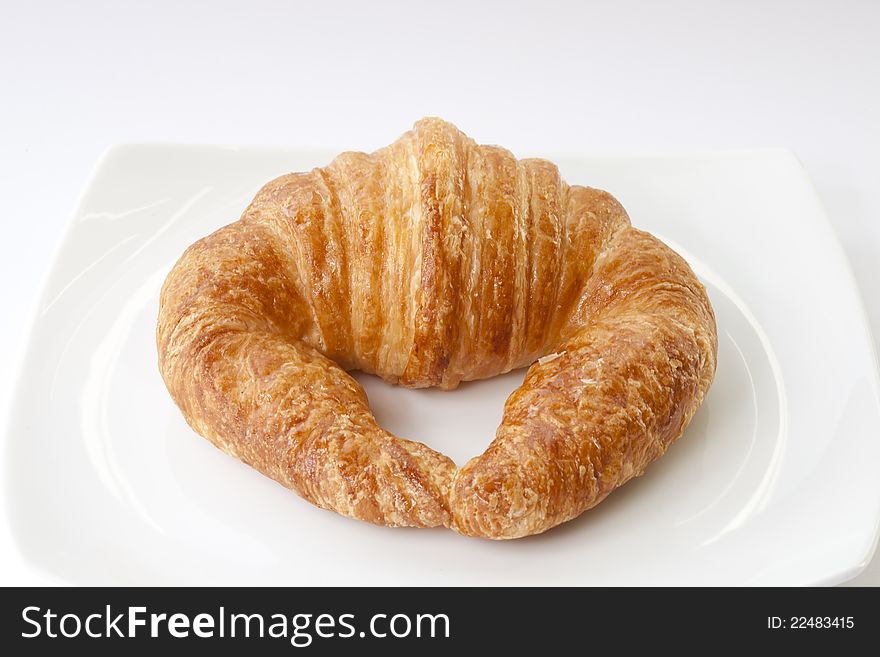 Fresh Croissant with caramelized white background