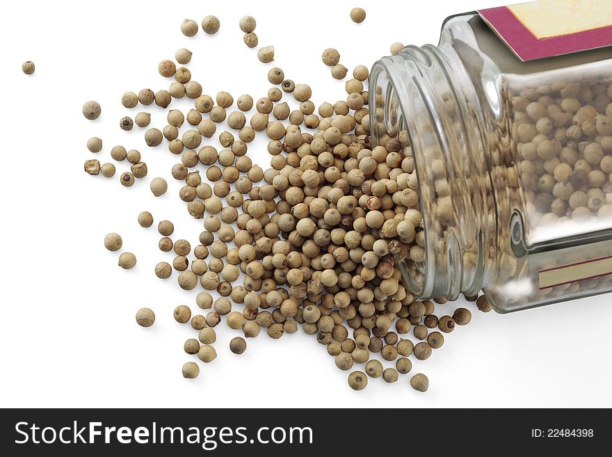 A jar with white peppercorns isolated over a white background