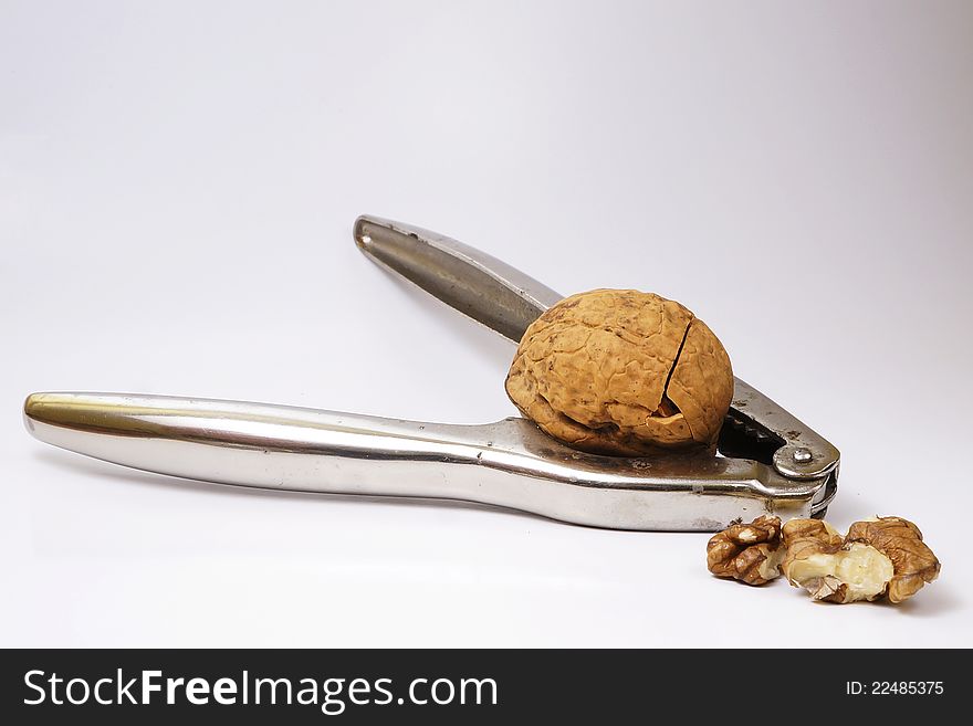 Old nutcracker with cracked walnut