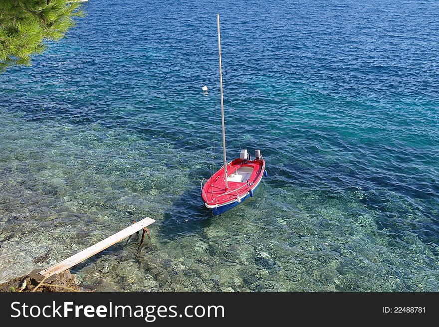 A small isolated boat sitting at the waters edge. A small isolated boat sitting at the waters edge