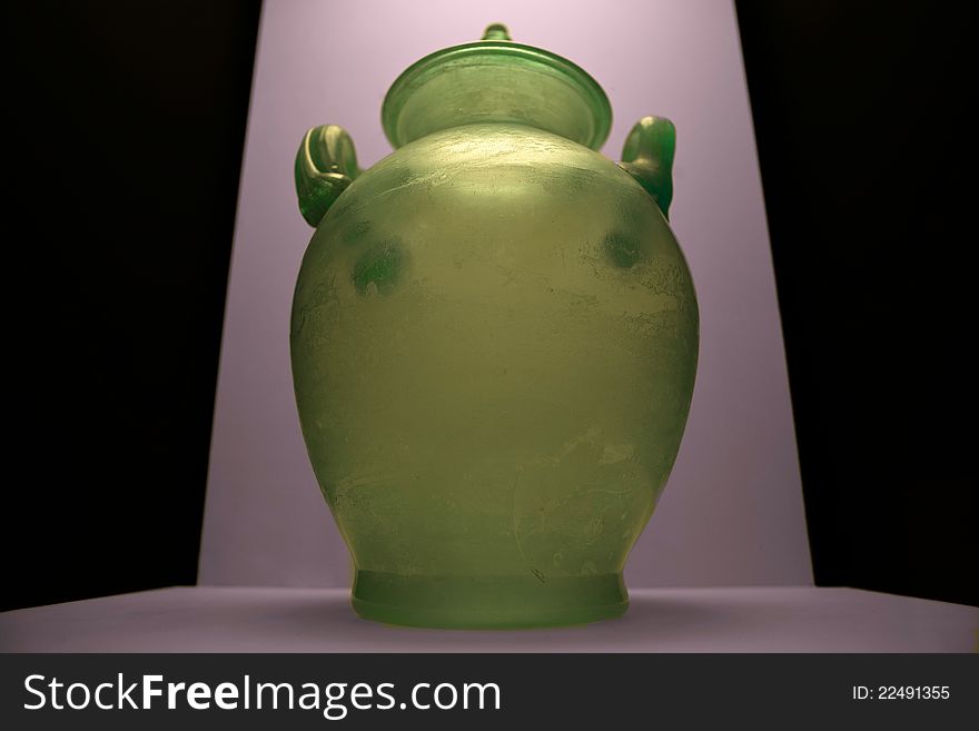 Thin-walled vase shaped two-handled vase, blown glass to air in greenish glass with ring base, globular body.