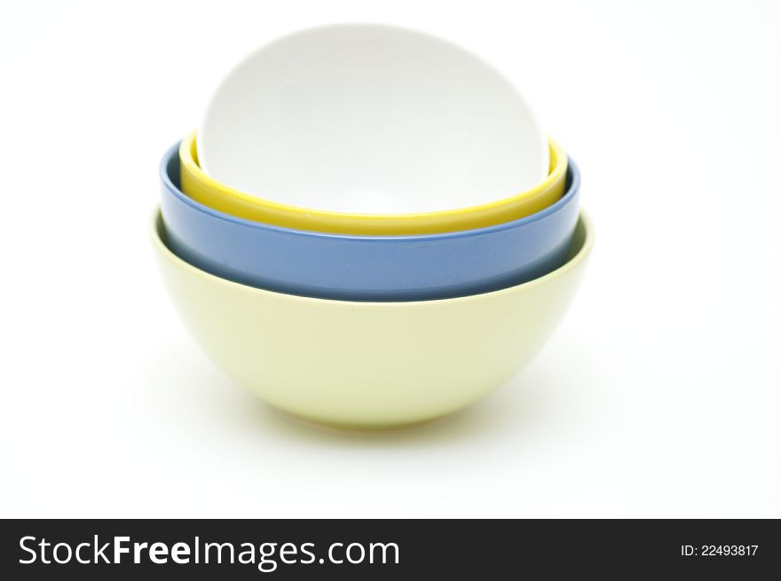 Green, blue, yellow and white plates on white background