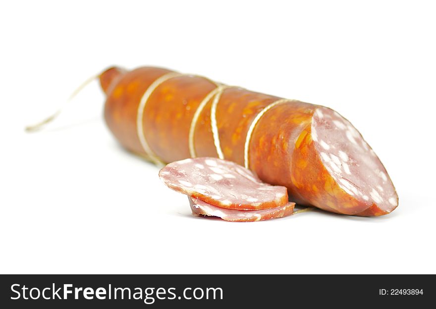 Sausage long loaf with one piece of sausage on white background