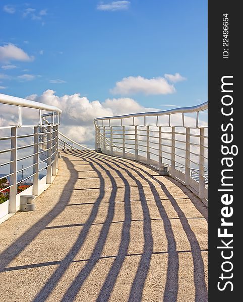 White pedestrian bridge over a highway in Majorca (Spain) with a blue sky background. White pedestrian bridge over a highway in Majorca (Spain) with a blue sky background