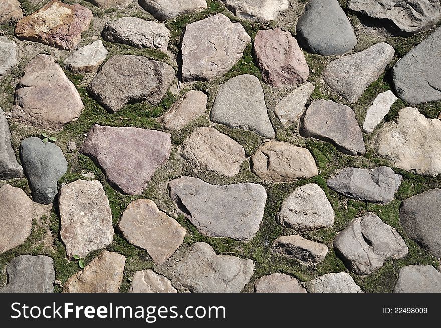 Closeup of old cobblestone pavement surface. Closeup of old cobblestone pavement surface