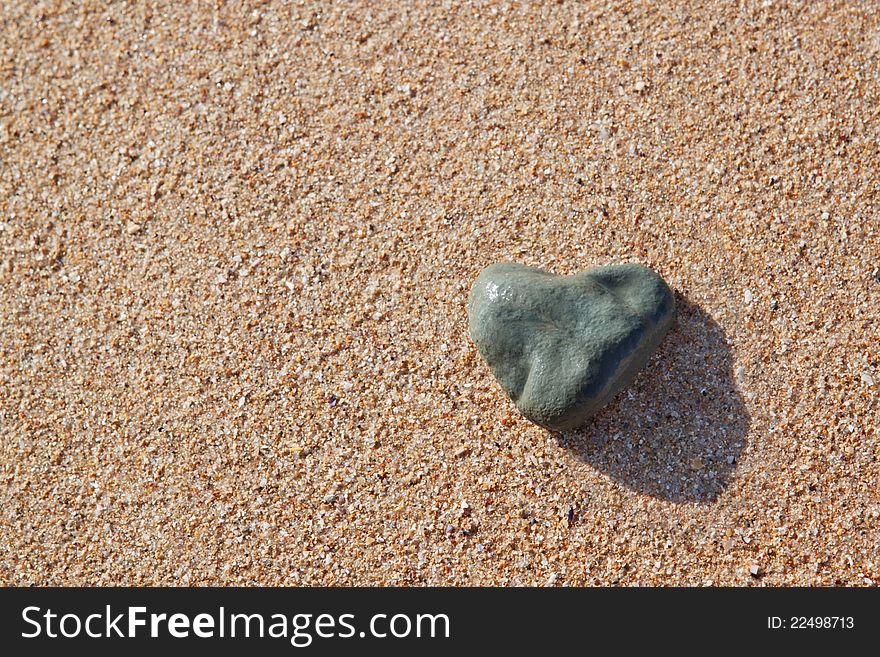 Stone in the shape of a heart on the beach.